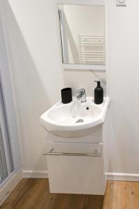 a bathroom with a sink and a mirror at La Pinta - Fécamp in Fécamp
