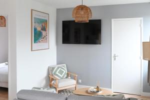 a living room with a couch and a chair at La Pinta - Fécamp in Fécamp