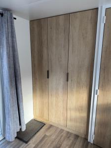 a closet with wooden doors in a room at Mobilhome camping le BOSC in Saint-Cyprien +2 photos