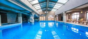 a swimming pool with blue water in a building at Valentina Castle in Ognyanovo +171 photos
