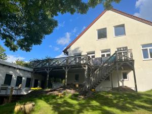 a house with a wooden deck on the side of it at Ferienhaus-am See in Glücksburg +20 photos