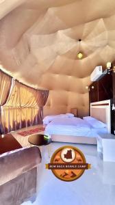 a hotel room with two beds and a table at RUM ROZA BUBBLES lUXURY CAMP in Wadi Rum