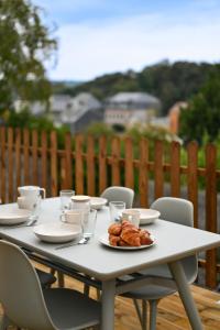 a white table with a plate of pastries on it at La Niña - Parking Gratuit in Fécamp
