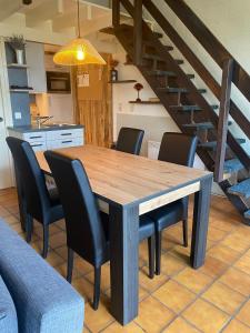 a dining room with a wooden table and chairs at Mon CoCoo in Stavelot
