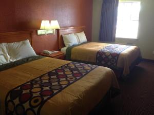 a hotel room with two beds and a window at Americas Best Value Inn Pryor in Pryor