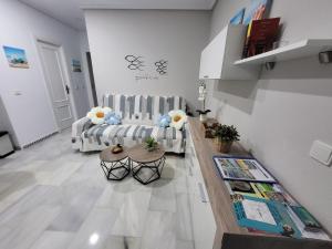 a living room with a couch and a table at Apartamento Pinar del Atlántico La Barrosa in Chiclana de la Frontera