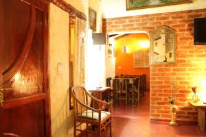 a room with a hallway with chairs and a table at Divina Presencia in Cafayate
