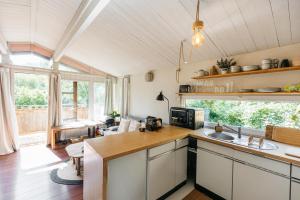 a kitchen with a sink and a counter top at Le Chalet de l'Ours, jacuzzi and private sauna in Insemont