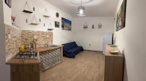 a kitchen with a sink and a stove in a room at Sonalerba Ammare Trabia H H in Trabia +9 photos