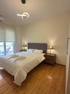 a bedroom with a large bed and two night stands at Hidden Gem Apartment in Patra