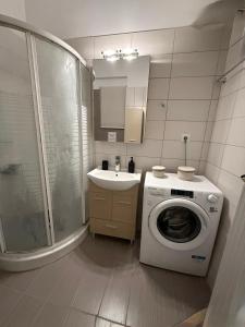 a bathroom with a washing machine and a sink at Hidden Gem Apartment in Patra +47 photos