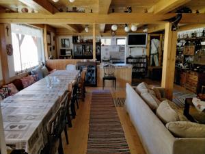 a large dining room with a long table and couches at Öreg Tornácos Lak in Lunca de Sus