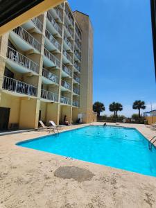 an empty swimming pool in front of a hotel at Gorgeous Ocean Views! Double Queen Sea Mist Suite! Sleeps 4! 50802 in Myrtle Beach
