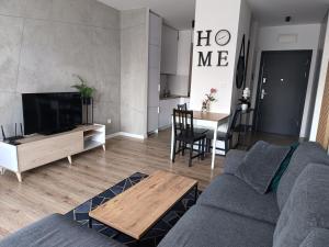 a living room with a couch and a table at Apartament Siedlce in Siedlce