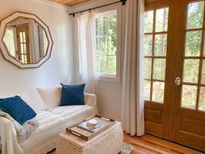 a living room with a couch and a mirror at The Ivywood in Guerneville