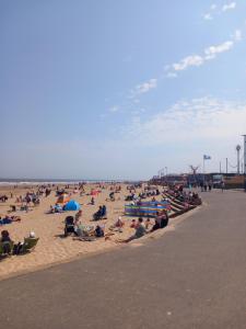 a crowd of people sitting on the beach at H21 holiday let in Mablethorpe