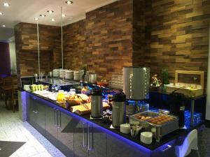 a buffet line in a restaurant with food at Breslauer Hof Am Dom in Cologne +27 photos