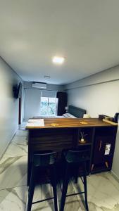 a room with a desk with two chairs and a keyboard at 2 de abril apartamento in San Miguel de Tucumán