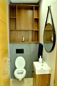 a bathroom with a toilet and a sink and a mirror at Hivernage Residence, Modern 2 Bedroom in Agadir