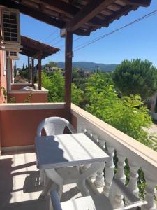a table and a chair on a balcony with a view at Panagiotis Studios 2 in Laganas