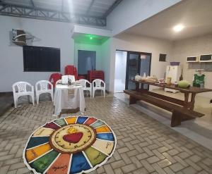 a dining room with a table and a table and chairs at Estilo resort para confraternizar com hidro, piscina, garagem em casa tudo privativo, insira acima de 6 hóspedes para usar os 3 quartos in Sorriso