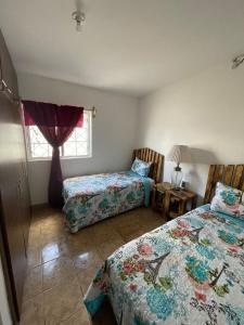a bedroom with two beds and a window at GR20acd Corredor Comercial in Cuauhtémoc