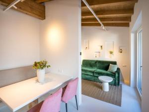 a living room with a green couch and pink chairs at PENTHOUSE N`1 - Stylish Apartment with Rooftop Whirlpool Access in Tyrol, presented by AlpenLuxus in Kramsach