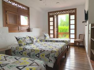 Postel nebo postele na pokoji v ubytování Casa Santa Rita - Habitación Cuadruple + 5 fotografií