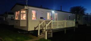 a tiny house on a deck at night at Bewles Caravan in Rhyl