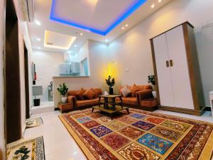 a living room with a couch and a table on a rug at مرفق الشلال السياحي in Jeddah +5 photos