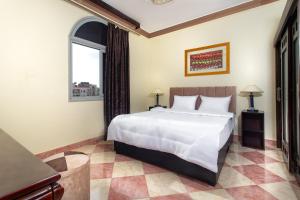 a bedroom with a large white bed and a window at Studio 1Bed Room Apartment in Hurghada