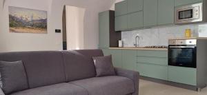 a living room with a couch and a kitchen at Au Valún - Cà Megiana in Camporosso