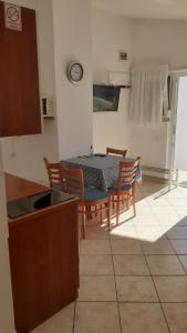 a kitchen and dining room with a table and chairs at Apartment Dobri in Batalaži +19 photos