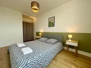 a bedroom with a bed with two pillows on it at Séjour détente à Blois - Parking & Netflix inclus in Blois