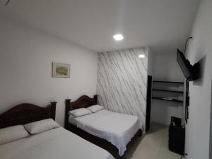 Voodi või voodid majutusasutuse Hotel Palmari toas