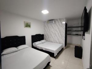 Voodi või voodid majutusasutuse Hotel Palmari toas