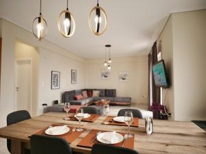 a dining room and living room with a table and chairs at Olive Heaven in Kalamata