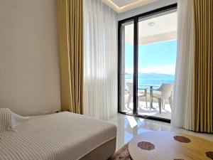 a bedroom with a bed and a view of the ocean at Jona's Luxury Saranda Escape in Sarandë