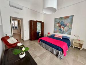 a bedroom with a large bed and a red chair at META CC PALACE with pool in Meta
