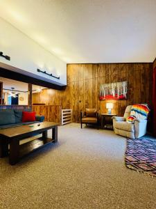 a living room with a couch and a table at Alpen Villa Escape at Powderhorn Mountain in Bessemer