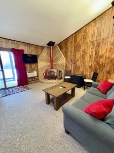 a living room with a couch and a table at Alpen Villa Escape at Powderhorn Mountain in Bessemer