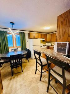a kitchen with a table and chairs and a dining room at Premium Slope-Side Escape I Alpen Villas at Powderhorn Mountain in Bessemer +13 photos