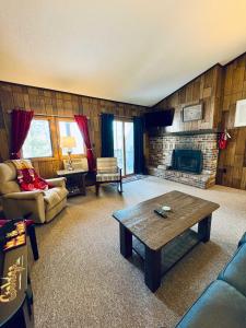 a living room with a couch and a fireplace at Winter Wonderland Getaway I Alpen Villas at Powderhorn Mountain in Bessemer