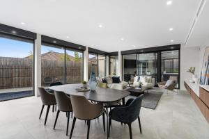 an open living room with a table and chairs at 5 Ensuite Luxury Holiday House Balwyn North in Melbourne