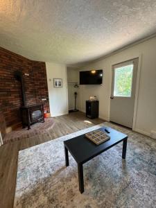 a living room with a coffee table and a fireplace at Elevated Ski Chalet at Powderhorn Mountain in Bessemer