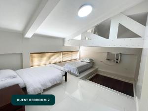 Postel nebo postele na pokoji v ubytování Coralpoint Gardens Suites & Residences