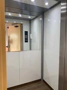 a sliding glass door with a mirror in a room at Mar Azul Flat in Salinópolis +16 photos