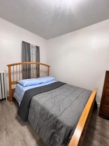 a bedroom with a bed and a dresser at Preston Serenity Room With Shared Bath & Kitchen in Hartford +8 photos