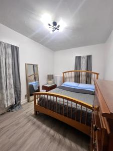 a bedroom with a bed and a ceiling fan at Preston Serenity Room With Shared Bath & Kitchen in Hartford