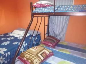 a room with two bunk beds in a room at House boat in Gerik